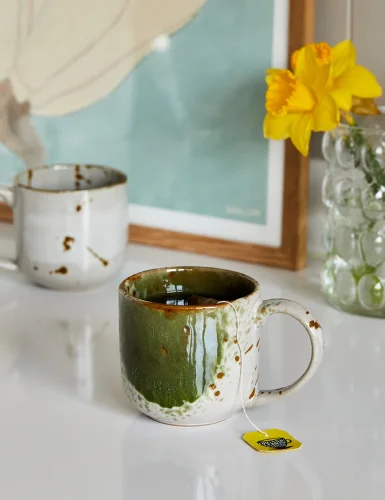 Green and brown spotted pottery mug