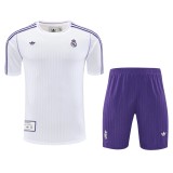 24-25 Real Madrid training kit with white striped top and purple shorts